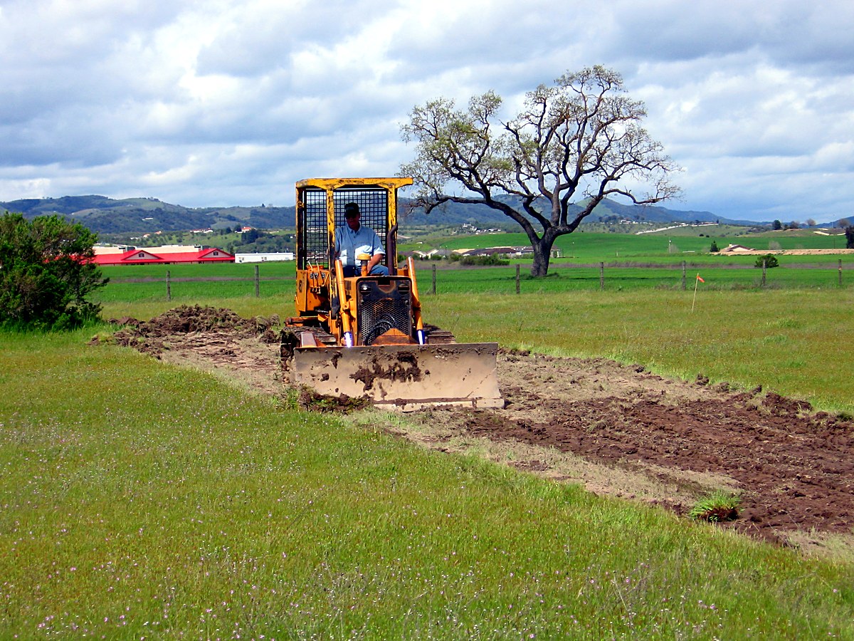 Tractor cutting the first grading pass on the Paso Robles lot